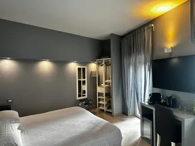 a bedroom with a white bed and a desk at Trastevere House B&B in Rome