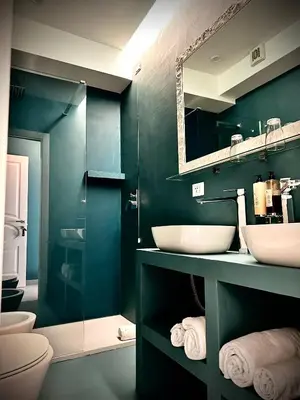 a bathroom with two sinks and a mirror at Trastevere House B&B in Rome