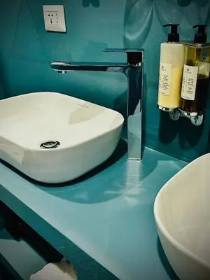 a bathroom with a white sink on a blue counter at Trastevere House B&B in Rome