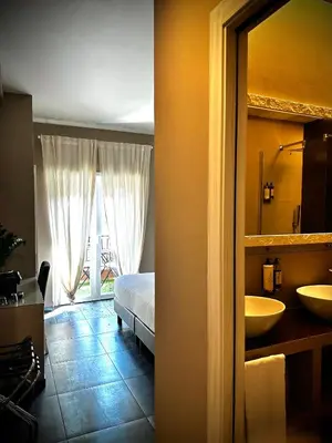 a bedroom with two sinks and a bed and a mirror at Trastevere House B&B in Rome