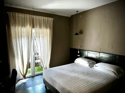 a bedroom with a bed and a large window at Trastevere House B&B in Rome