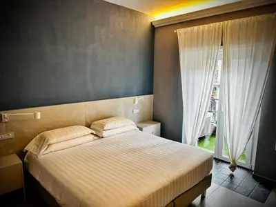 a bedroom with a bed and a large window at Trastevere House B&B in Rome