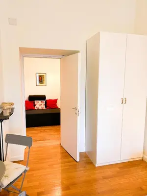 a room with a bed and a room with a closet at San Pietro Prestige Rooms in Rome