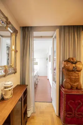 a hallway with a large statue on a table in a room at Trastevere 2 BR Cozy Apartment in Rome