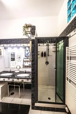 a bathroom with two sinks and a shower at Trastevere 2 BR Cozy Apartment in Rome