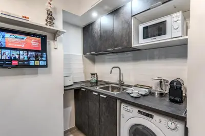 a kitchen with a washing machine and a sink at Flaminio Royal Apartment in Rome