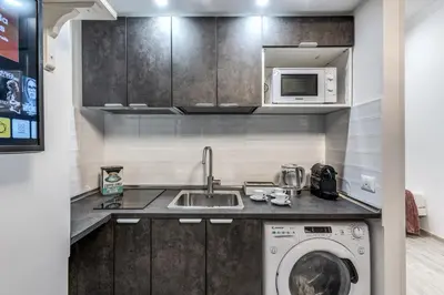 a kitchen with a sink and a washing machine at Flaminio Royal Apartment in Rome