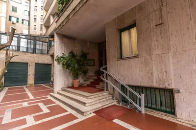a building with stairs and a window and a plant at Flaminio Royal Apartment in Rome