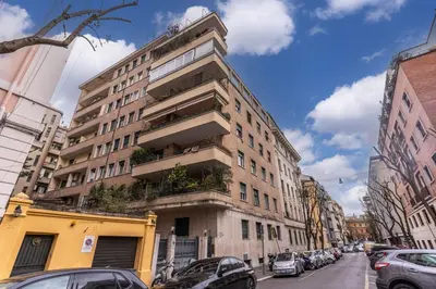 a tall building on a city street with cars parked at Flaminio Royal Apartment in Rome