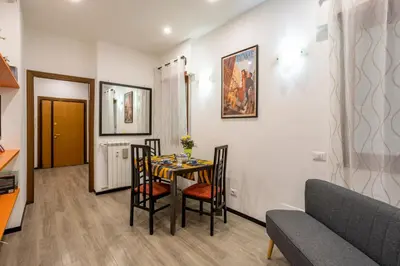a dining room with a table and chairs and a couch at My Vatican Home in Rome in Rome