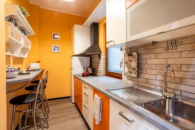 a kitchen with yellow walls and a sink and counters at My Vatican Home in Rome in Rome