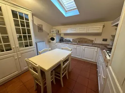 a kitchen with a table and chairs and a skylight at The Vatican Jungle loft con giardino vicino al Vaticano in Rome