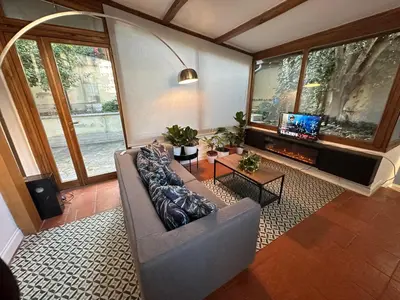 a living room with a couch and a tv at The Vatican Jungle loft con giardino vicino al Vaticano in Rome