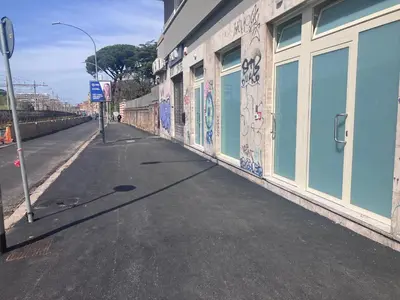 an empty street with graffiti on the side of a building at Capitolina - apartments in Rome