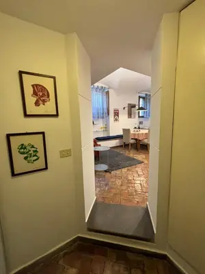 a hallway with a stairway leading to a living room at BBB House in Rome