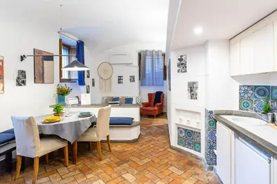 a kitchen and living room with a table and chairs at BBB House in Rome