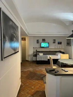 a living room with a bed and a television at BBB House in Rome