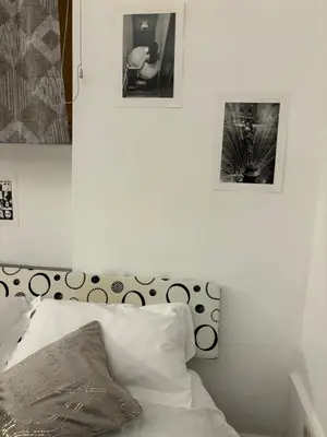 a bedroom with a bed and two pictures on the wall at BBB House in Rome