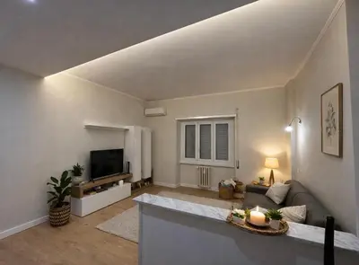 a living room with a couch and a tv at CASA DEL SOLE in Rome