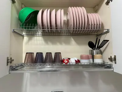 a kitchen shelf with plates and utensils at CASA DEL SOLE in Rome