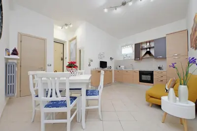 a kitchen and living room with a table and chairs at Roma & Amor Apartment in Rome