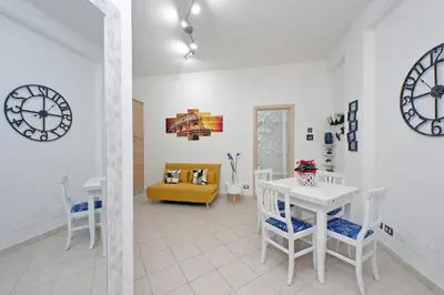 a living room with a table and a yellow couch at Roma & Amor Apartment in Rome