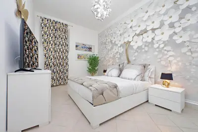 a bedroom with a white bed and a tree mural at Roma & Amor Apartment in Rome