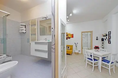 a bathroom with a sink and a toilet and a table at Roma & Amor Apartment in Rome