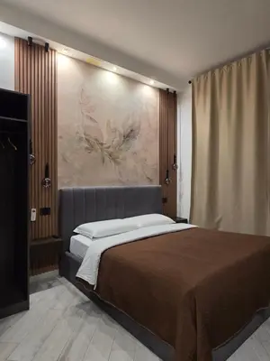 a bedroom with a bed with a painting on the wall at B&B Sol Romae in Rome