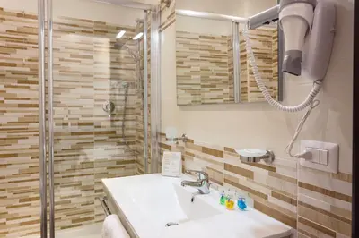 a bathroom with a sink and a shower at B&B Sol Romae in Rome