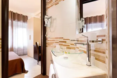 a bathroom with a sink and a mirror at B&B Sol Romae in Rome