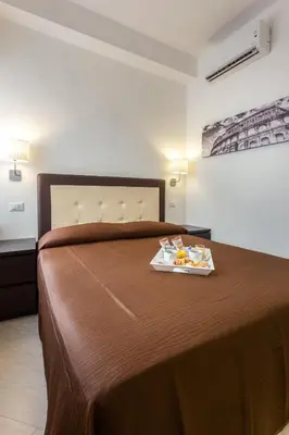 a hotel room with a bed with a tray of food on it at B&B Sol Romae in Rome
