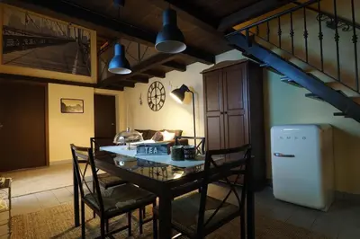 a dining room with a table and a refrigerator at Loft Germanico in Rome