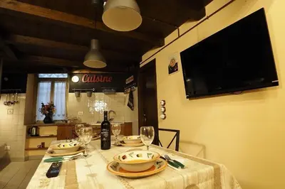 a table with plates and wine glasses on it at Loft Germanico in Rome