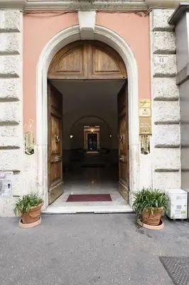 an entrance to a building with two potted plants at Loft Germanico in Rome