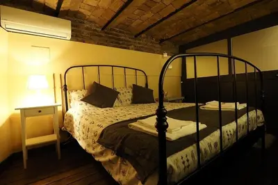a bedroom with a bed and a night stand with a lamp at Loft Germanico in Rome