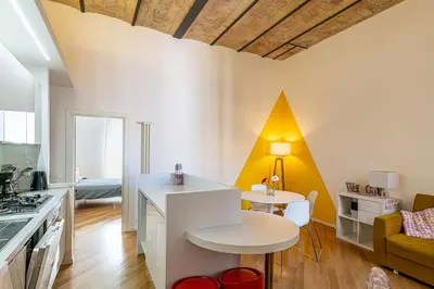 a kitchen and living room with a table and chairs at CasaLu San Pietro in Rome