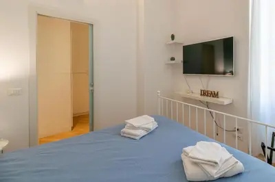 a bedroom with a bed with two towels on it at CasaLu San Pietro in Rome