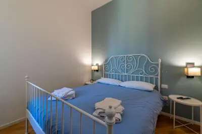 a blue bed with a blue headboard in a bedroom at CasaLu San Pietro in Rome
