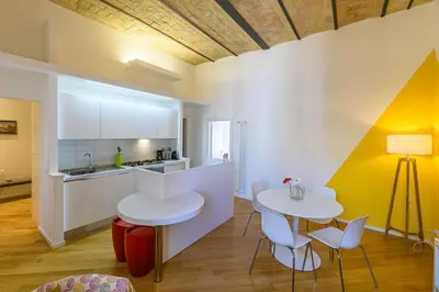 a kitchen with two white tables and chairs in a room at CasaLu San Pietro in Rome