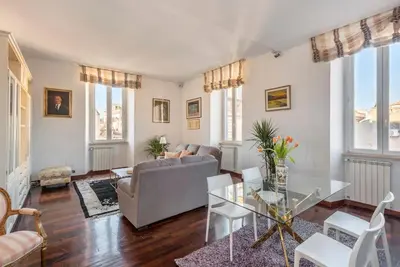a living room with a couch and a glass table at Stunning Center Rome Apartment in Rome