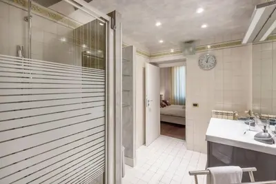 a bathroom with a shower and a sink and a tub at Stunning Center Rome Apartment in Rome