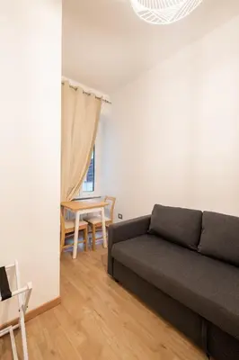 a living room with a couch and a table at DOMUS TRAIANA in Rome