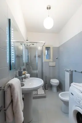 a bathroom with a sink and a toilet and a shower at DOMUS TRAIANA in Rome