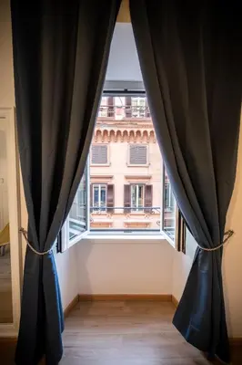 a window with black curtains in a room at DOMUS TRAIANA in Rome