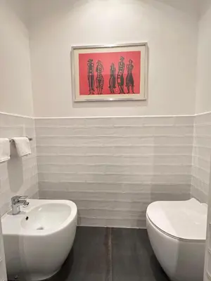 a bathroom with a white toilet and a sink at St. Peter's Balloon a due passi da San Pietro! in Rome