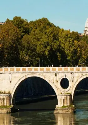 a bridge over the water with people on it at Casa Vicolo Moroni - Trastevere in Rome