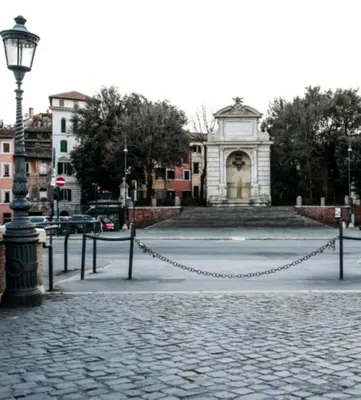 a cobblestone street with a chain in front of a building at Casa Vicolo Moroni - Trastevere in Rome