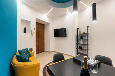 a meeting room with a yellow chair and a table at Lifestyle Vatican Apartment in Rome