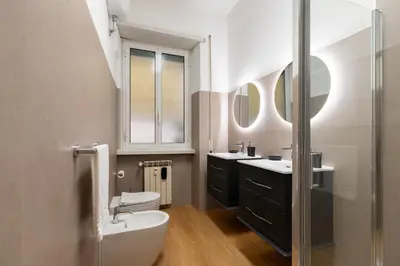 a bathroom with two sinks and a tub and a toilet at Lifestyle Vatican Apartment in Rome